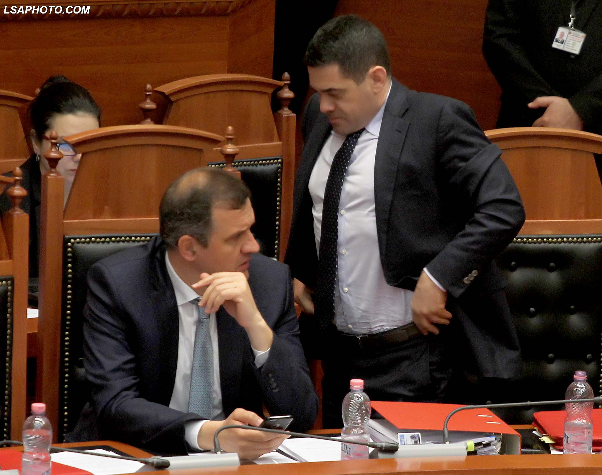 Ministri i Shendetesise Ilir Beqaj dhe Ministri i Financave, Arben Ahmetaj, gjate nje seance parlamentare, ku eshte diskutuar ne lidhje me ndryshimin e marreveshjes se koncesionit me shoqerine "Tirana Airport Partners", e cila synon ti hape rrugen ndertimit te aeroporteve te reja ne Shqiperi. /r/n/r/nHealth Minister Ilir Beqaj and Minister of Finance, Arben Ahmetaj, during a parliamentary session.