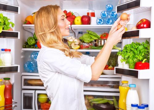 woman-getting-eggs-refrigerator